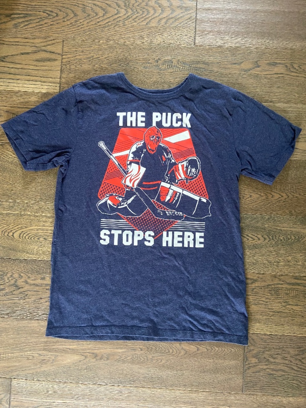 EUC: Children’s Place Navy Blue Hockey Goalie “Puck Stops Here” Graphic T 10-12Y